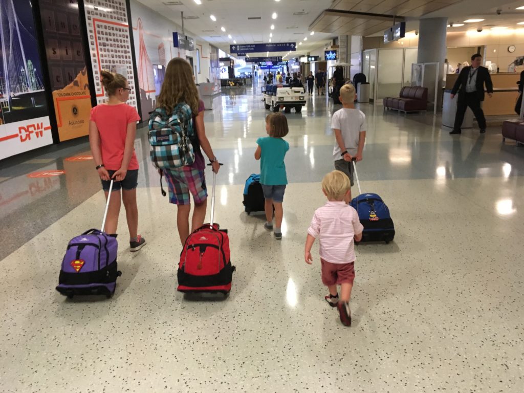 Kids carrying luggage in airport