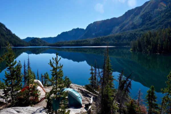 Tents camped on a lake in the Sawtooth Mountains of Idaho