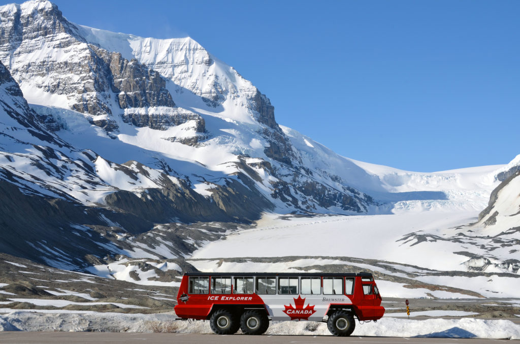 Parking snowcoach, used for tours in front of the Athabasca Glacier at the Columbia Icefield.