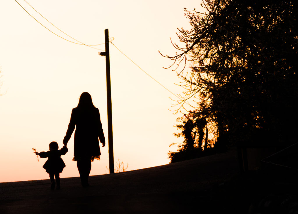 Woman and child taking a sunset walk in Zukovica, Montenegro
