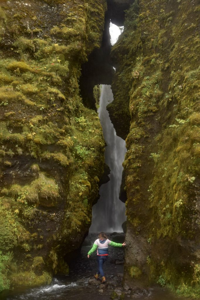 Walking through the hidden canyon to Gljufrabui Falls, Iceland