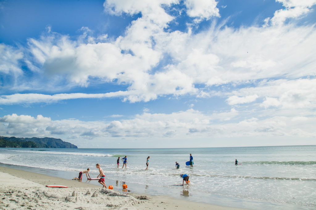 Kids playing on Waihi Beach New Zealand