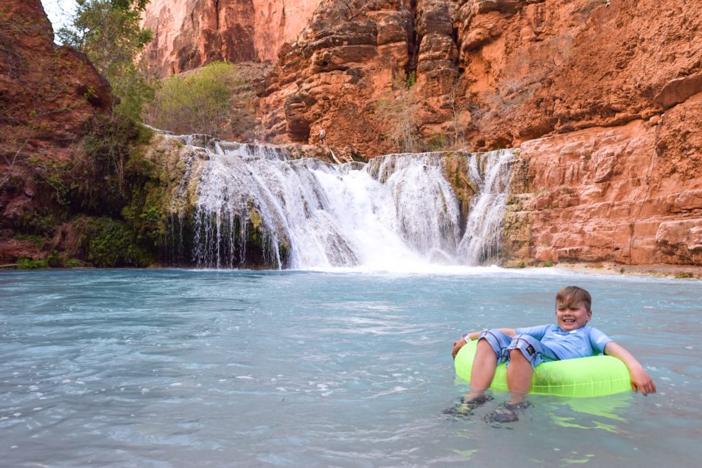Kid floating in tube at Beaver Falls, Havasupai, Arizona