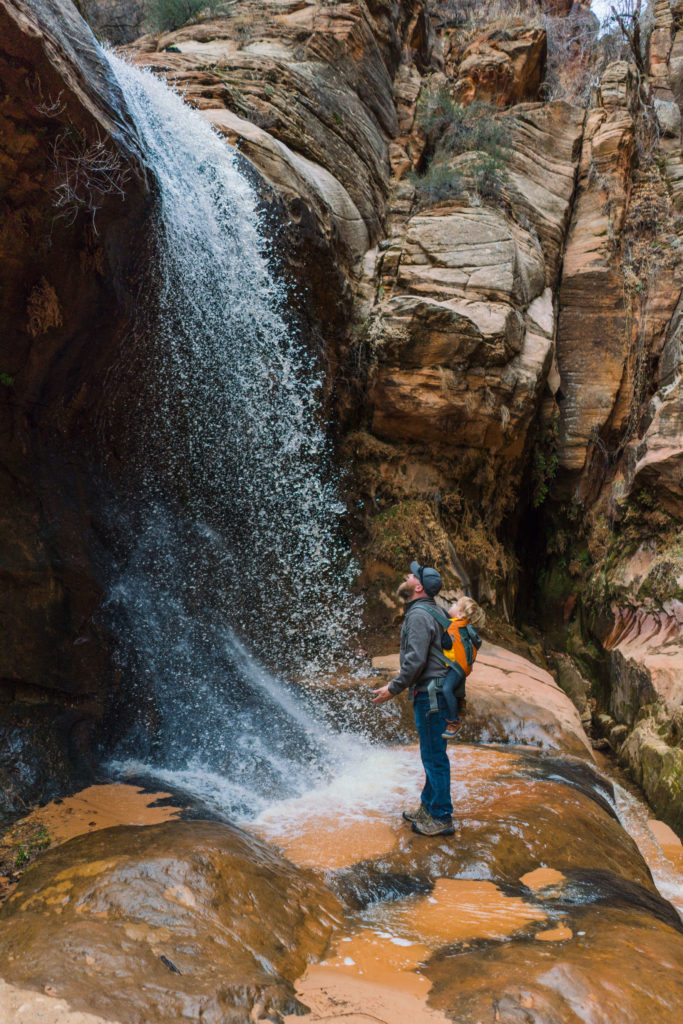 Dad and kid near waterfall in Water Canyon in Cannan and just outside Hildale, Utah