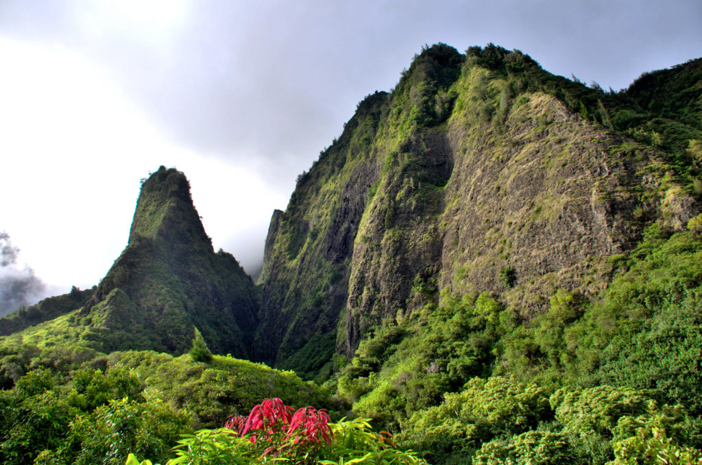Scenic Iao needle located on Maui, Hawaii. Tropical travel destination. Lush tropical foliage, mountains and valleys.