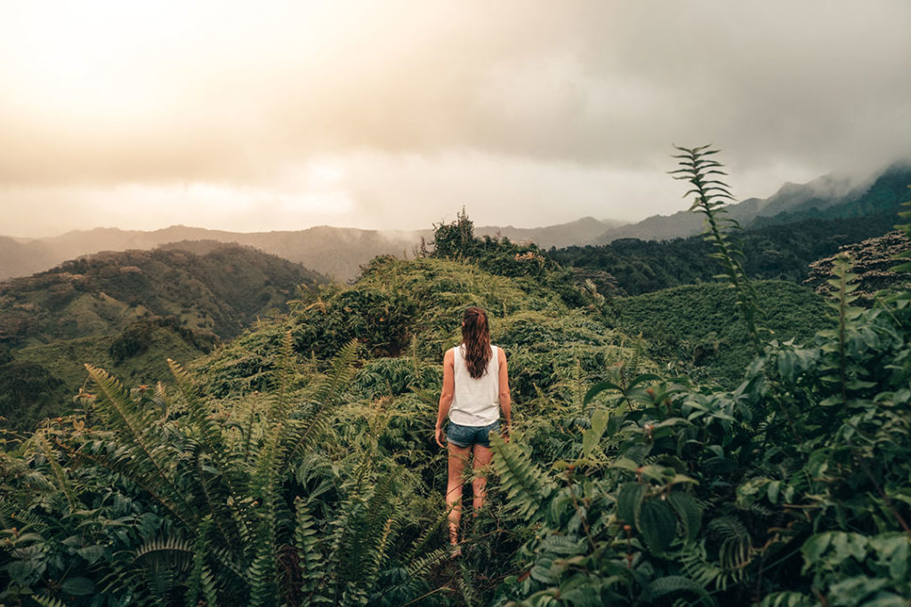 Woman hiking along the Kuilau Ridge trail in Kauai, Hawaii.