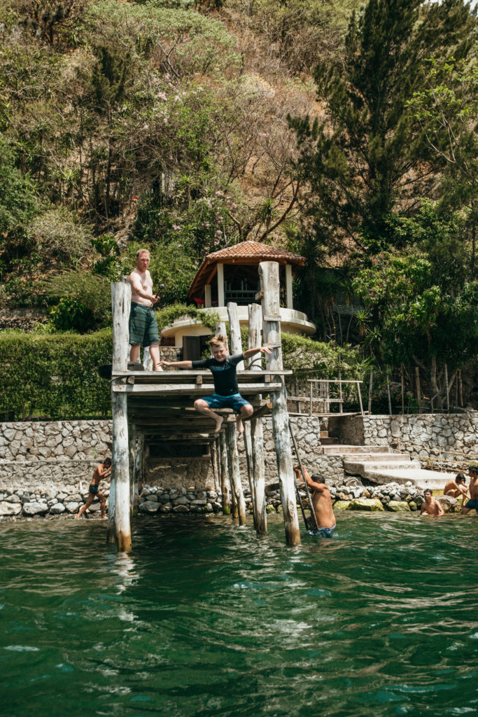 Kid jumping off dock on Lake Atitlan, Guatemala