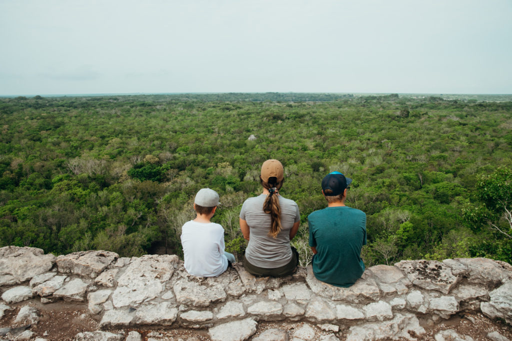 Family sitting on top of Coba ruins, Mexico