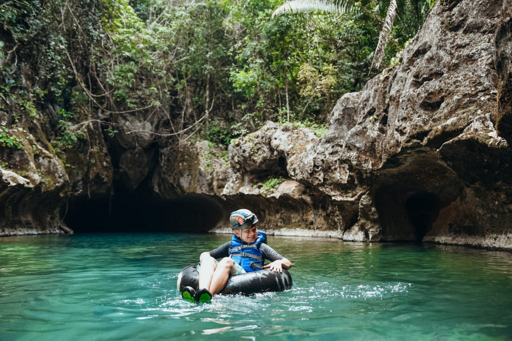 Kid tubing at Cave's Branch, Nohoch Che'en, Belize