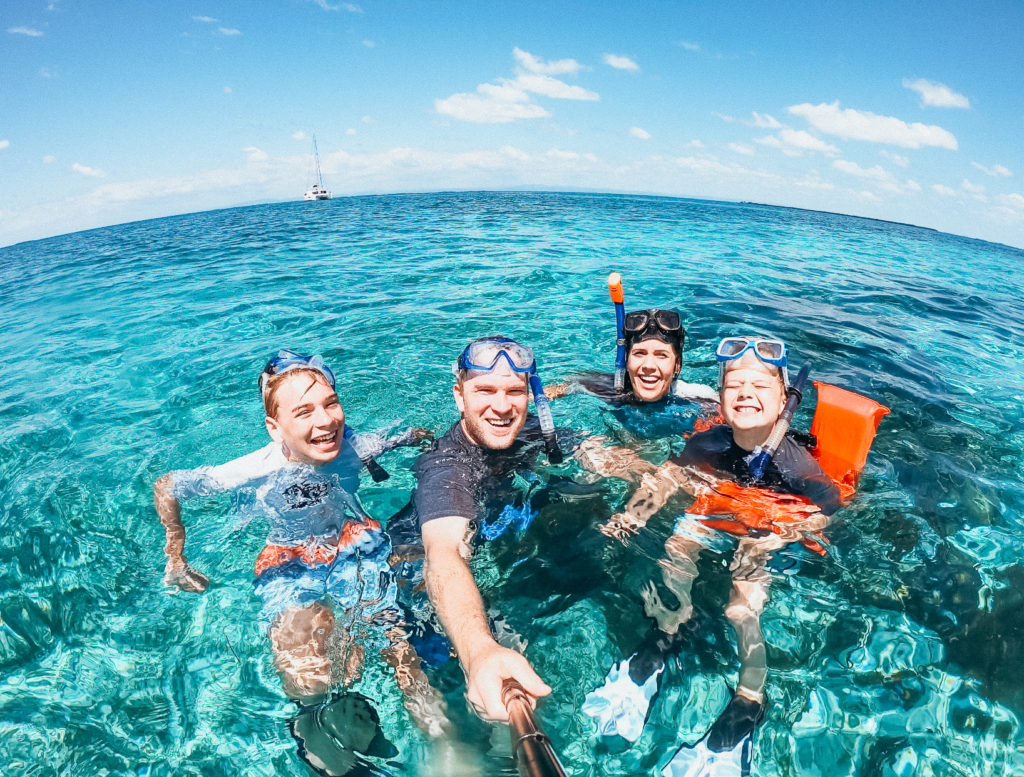 Family snorkeling on reef in Belize