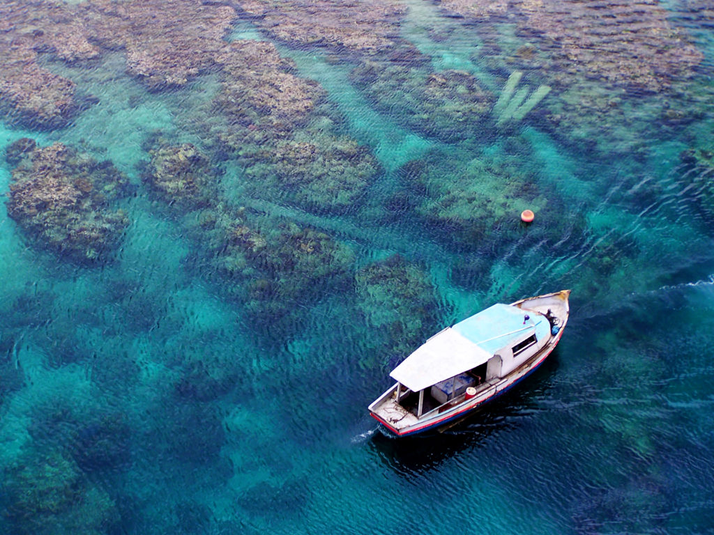 Aerial view of a boat over the Belize Reef