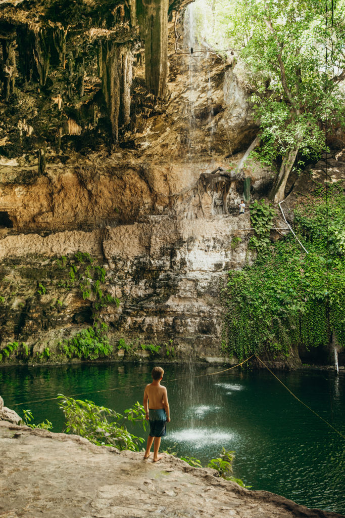 Kid getting ready to swim at Cenote Zaci, Valladolid, Mexico