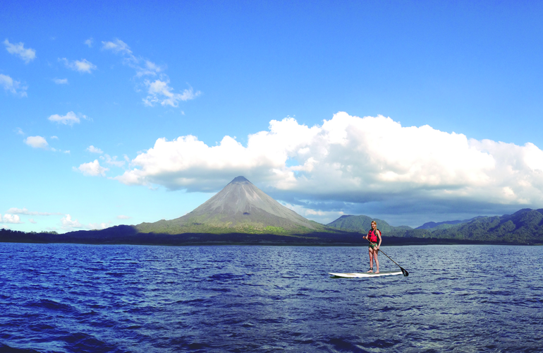 Paddleboarding on Lake Arenal with the majestic Volcano Arenal in the background, Costa Rica.