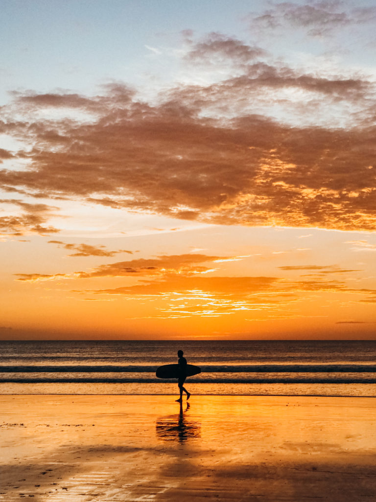 Surfer at sunset on Playa Langosta, Costa Rica