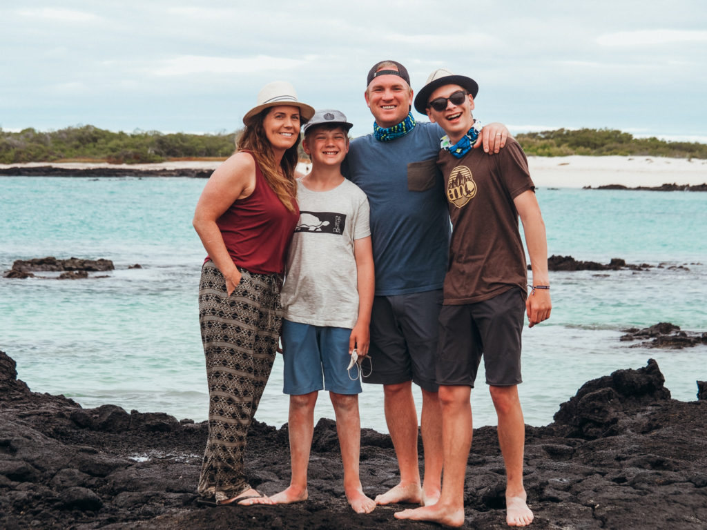 Family on beach in the Galapagos Islands, Ecuador