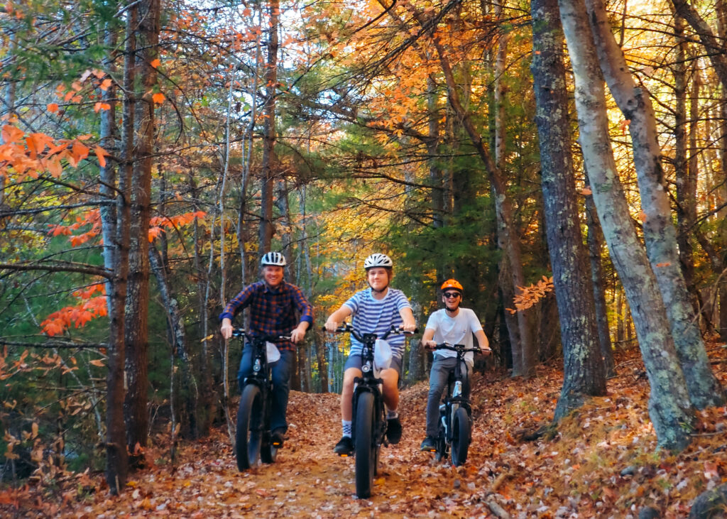 Family mountain biking on trail with Fall foliage in Pipestem Resort State Park, West Virginia