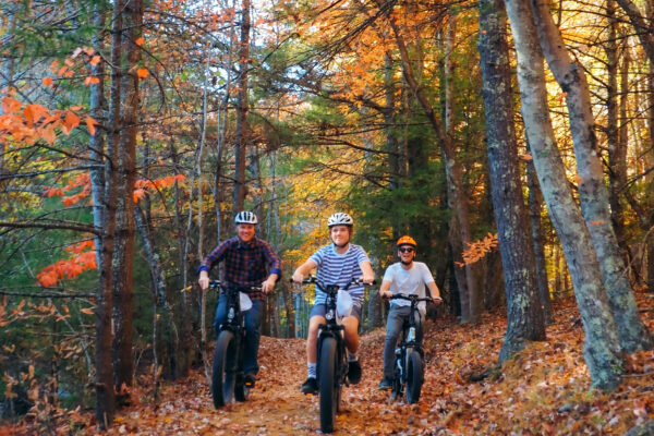 Family mountain biking on trail with Fall foliage in Pipestem Resort State Park, West Virginia